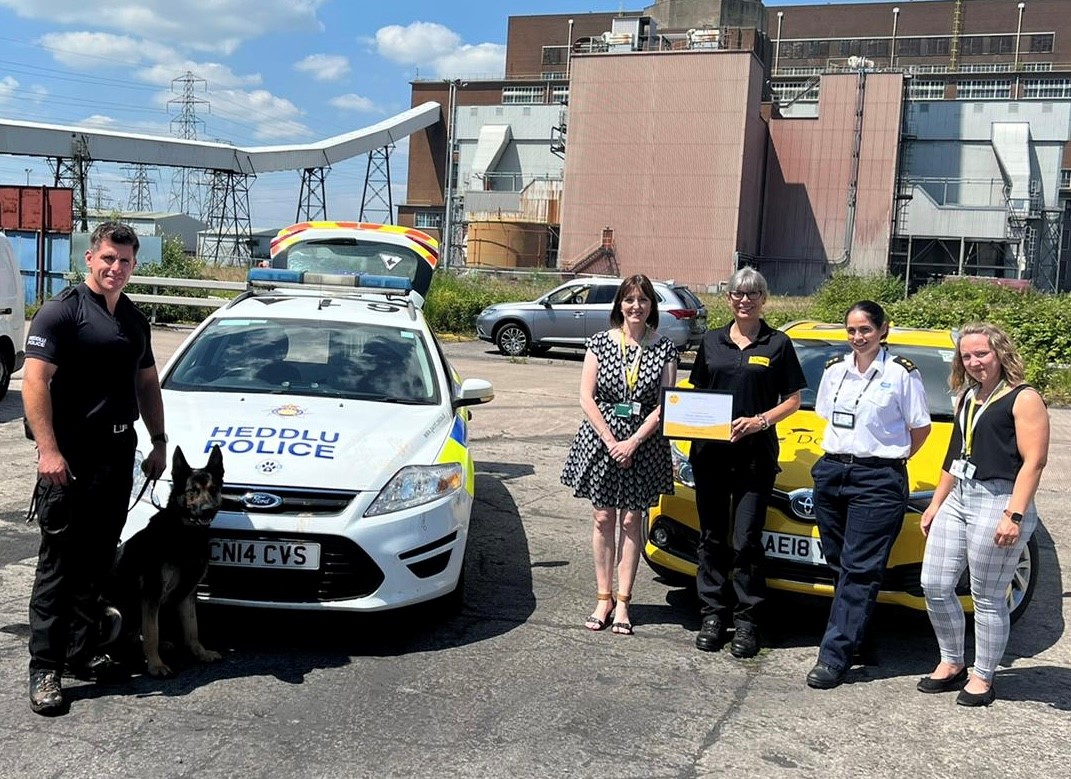 Staff with police dog and certificate 