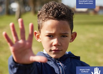boy with hand stretched out indicating STOP