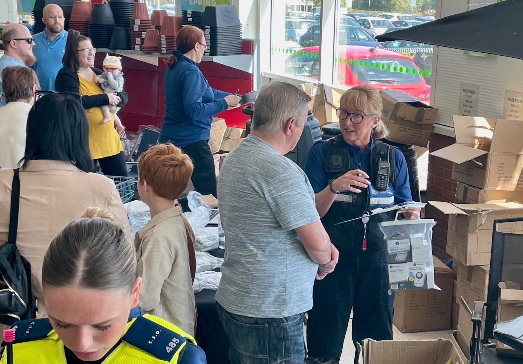 People gathered talking to officers at crime prevention event
