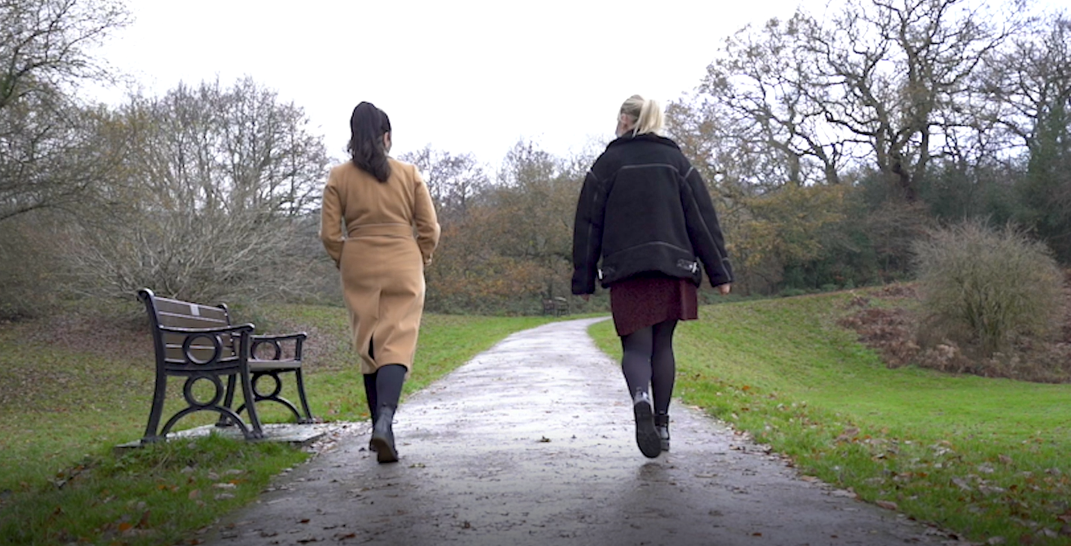 two women walking along path
