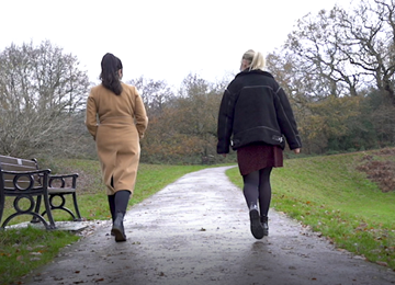 two women walking along path