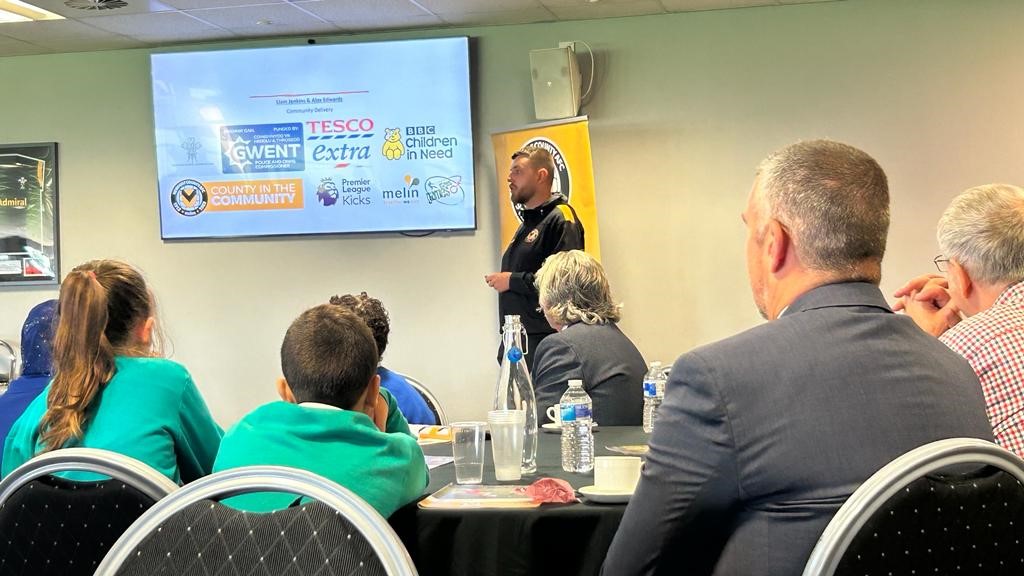 Representative from County in the Community presenting to audience 