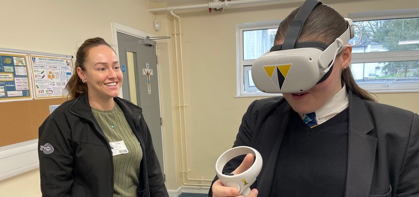 Representative from Willmott Dixon with girl wearing VR headset