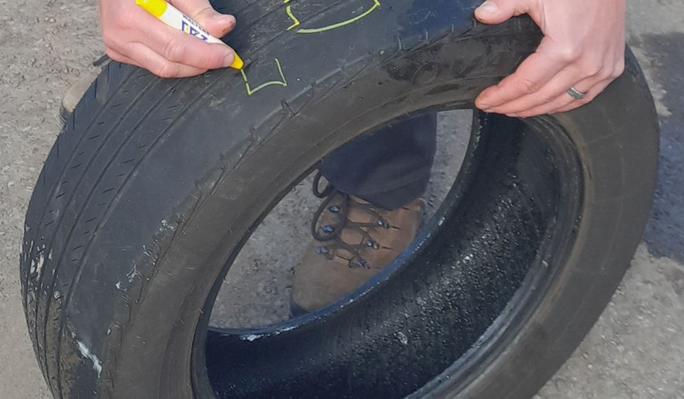 tyre being marked with yellow crayon