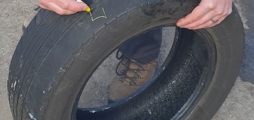 tyre being marked with yellow crayon