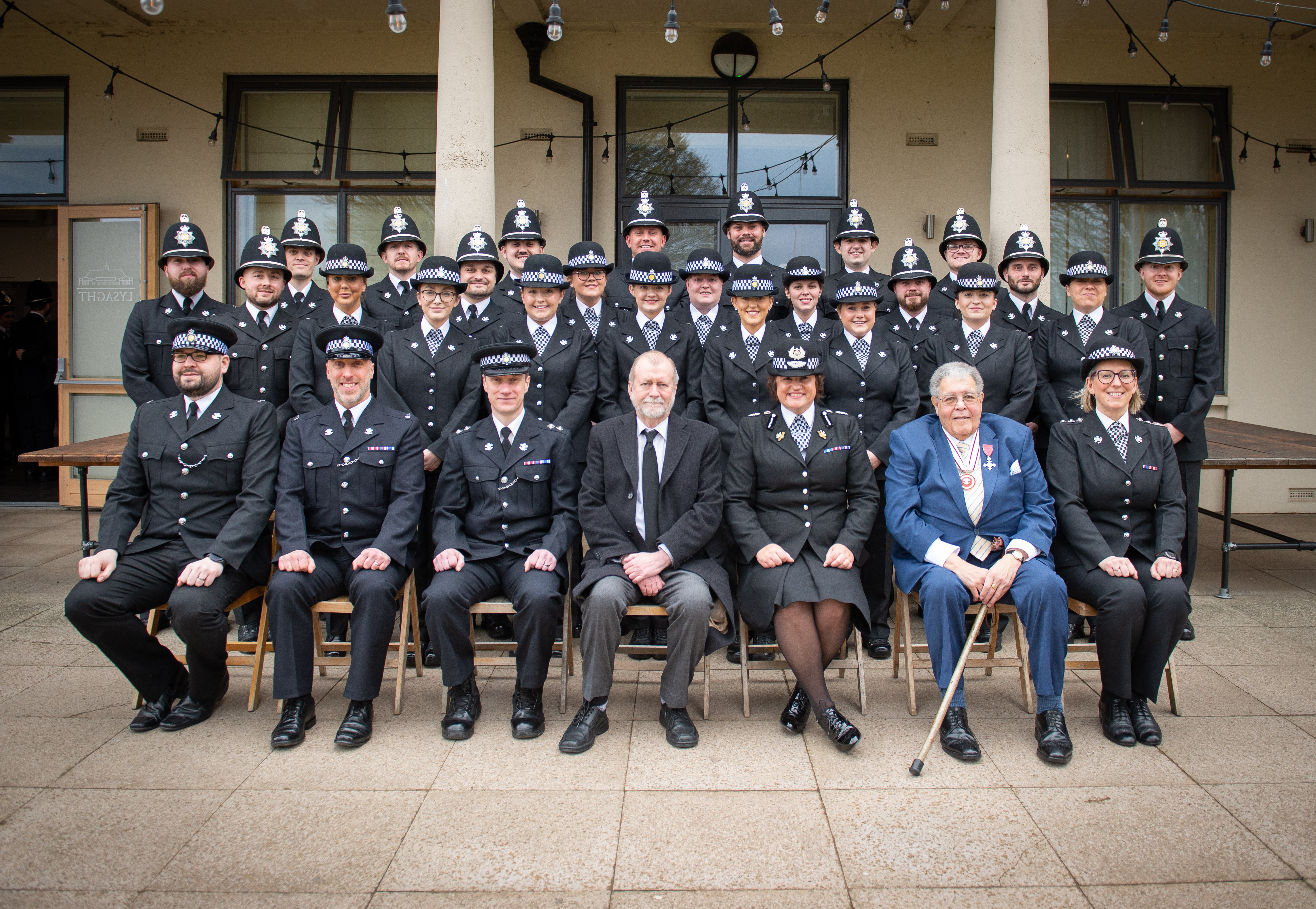 Jeff Cuthbert with sitting with graduating officers and other dignitaries 