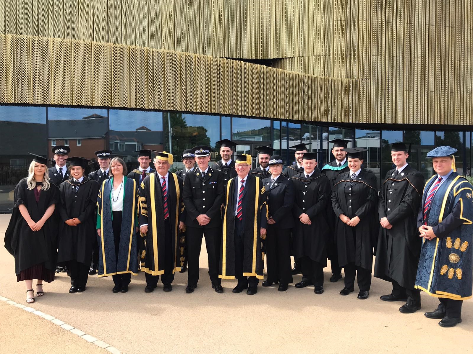 Gwent Police officers and representatives in graduation gowns