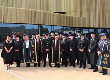 Gwent Police officers and representatives in graduation gowns