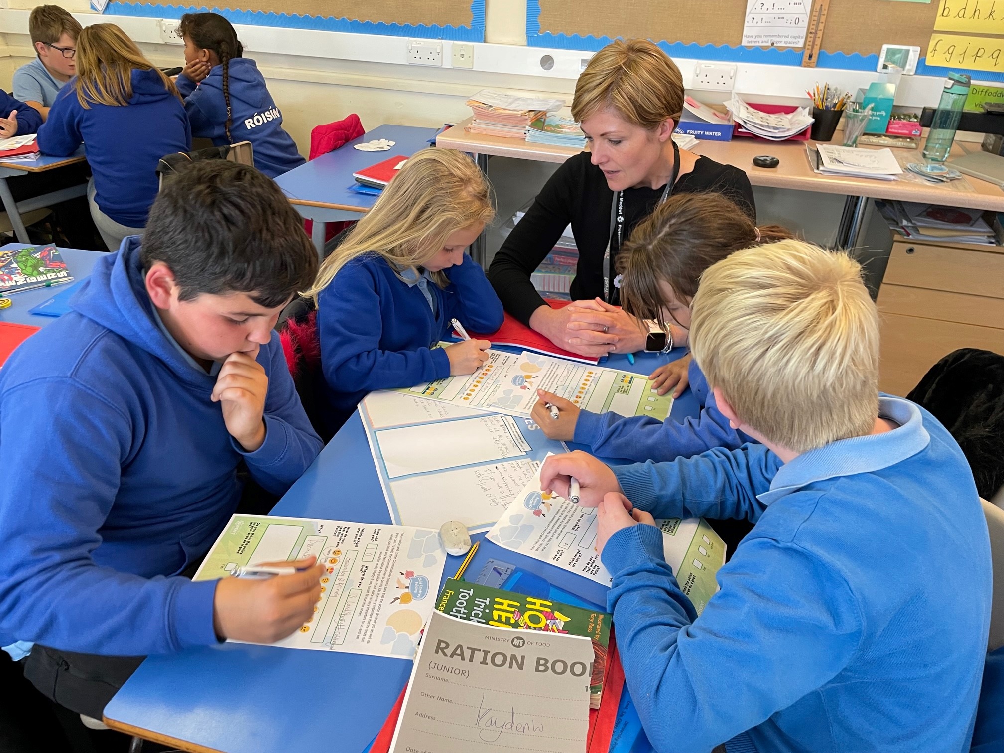 Member of the OPCC talking to children who are completing surveys