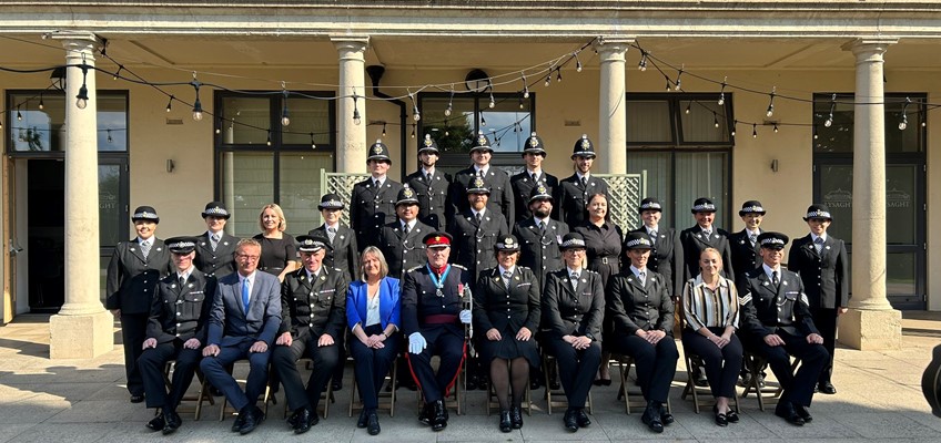 Police officers and dignitaries posed formally for photo
